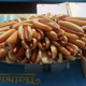 a large quantity of hot dogs piled on a table